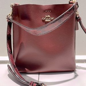 Burgundy Coach bucket purse with gold trim